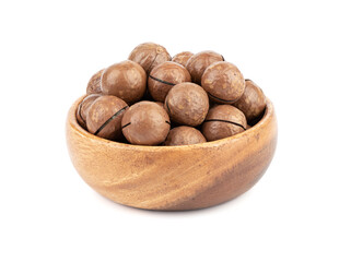 Wooden bowl full of macadamia nuts on a white background.