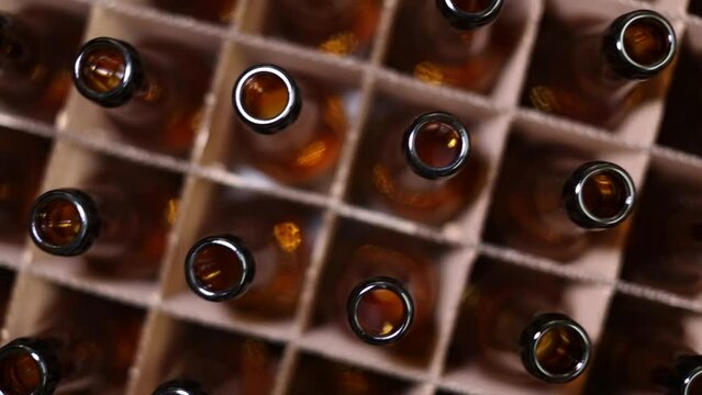Aerial view of amber beer bottles in a box