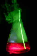Strong chemical reaction with a lot smoke and vapors inside Erlenmeyer flask. School chemical...