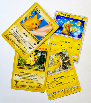 Hamburg, Germany - 08 19 2022: photo of different pikachu pokemon cards on white paper background.
