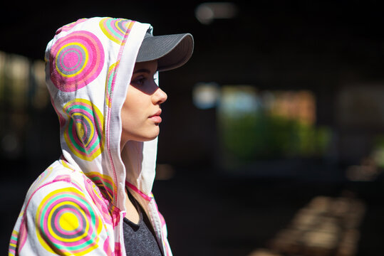Young female hip hop dancer standing in abandoned building on a sunny summer day