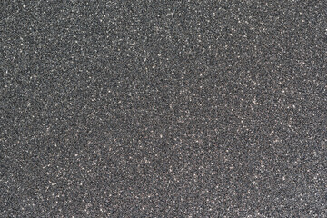 Shiny and sparkling dark grey colored glitter background. 