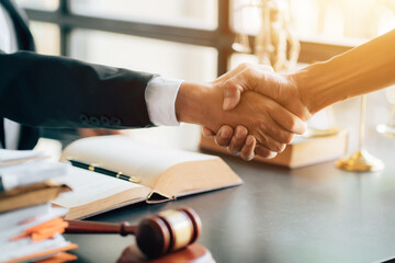 Businessman shaking hands to seal a deal with his partner lawyers or attorneys discussing a contract agreement.Legal law, advice, and justice concept. 