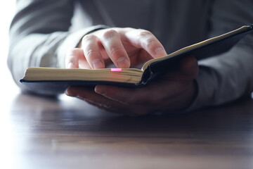 Read book. A man sits and reads literature. Textbooks to study. Religion.