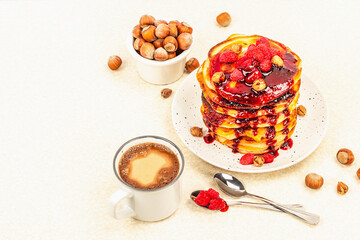 Traditional homemade breakfast with pancakes and coffee. Raspberry, hazelnut, sweet jam