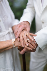 Close-up of seniors hands with wedding rings during their marriage.