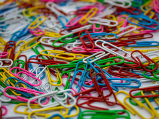 close up selective focus of colorful paperclip as a background and texture with white background in the office