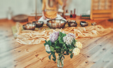 beautiful woman playng on tibetan bowl, ceremonial space.