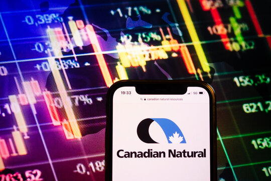 KONSKIE, POLAND - August 10, 2022: Smartphone Displaying Logo Of Canadian Natural Resources Company On Stock Exchange Chart Background