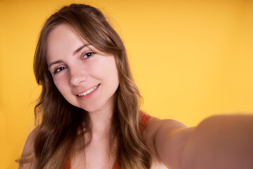 Caucasian teenage girl making selfie in studio shot