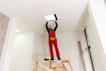 Ceiling installation with expert technicians In the room that is in the construction process. © Angelov