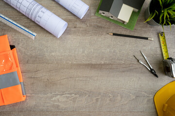 Flat lay of top view desk work table Engineer with Blueprint drawing,Helmet,architect design...