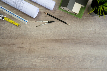 Flat lay of top view desk work table Engineer with Blueprint drawing,Helmet,architect design...