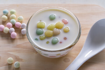 Bua Loi dessert, colorful bua loi in coconut milk  Soft and chewy jelly dough Sweet, mellow flavor, fragrant coconut milk, delicious Thai desserts in a glass cup.
