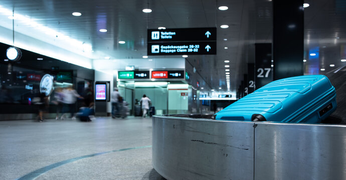 Arrived Luggage Going Around On A Conveyor Belt Waiting To Be Claimed At The Baggage Claim Zone At A Modern International Airport