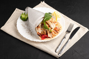 Shawarma with chicken, large portion of shawarma with chicken, side view, black background