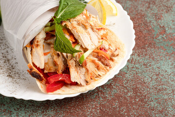 Shawarma on a plate, a large portion of shawarma on a plate, side view