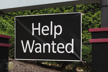Help Wanted sign outdoors for all to see that they eed to fill some jobs.