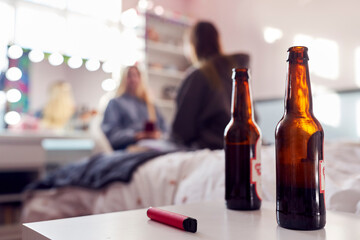 Group Of Teenage Girls In Bedroom With Bottles Of Beer And Vape Pen In Foreground