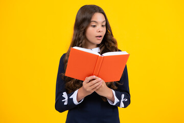 Obraz premium School child with book. Learning and education. Surprised emotions of young teenager schoolgirl.