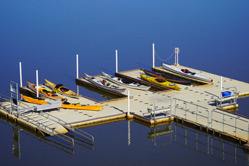 Colorful kayaks on a dock by a lake