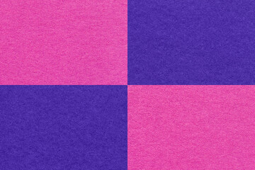 Texture of craft navy blue and purple paper background with cells pattern, macro. Vintage dense fuchsia kraft cardboard.