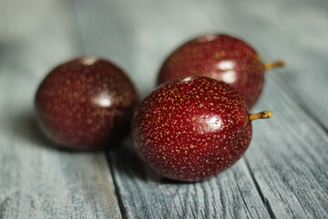 red passion fruit on white wooden backdrop