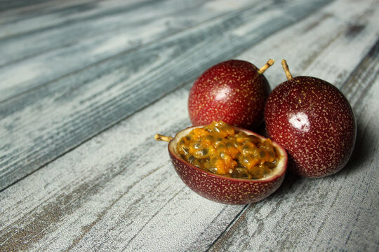 red passion fruit on white wooden backdrop