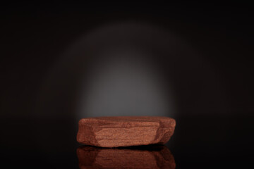 Narural stone as podium for packaging and cosmetic presentation on black background, copy space.