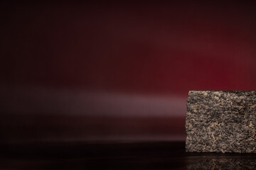 Minimalist, natural granite platform on a black background. Product presentation.