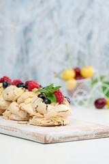 A baked cake made from whipped chicken protein and cream, decorated with fresh berries