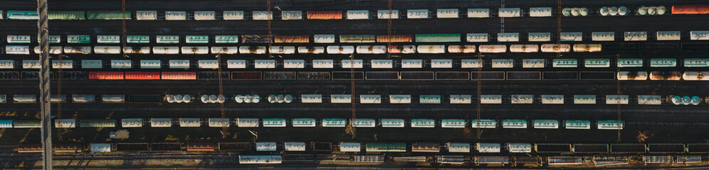 Top down panorama of cargo train station with tanks, wagons and trains. Logistic background