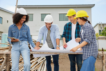 workers or architect meeting and looking at blueprint paper on the construction site