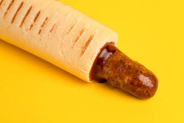 french hot dog, yellow background side view