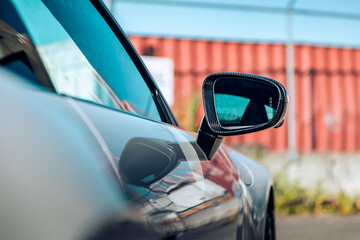 Passenger mirror of a car being viewed from behind