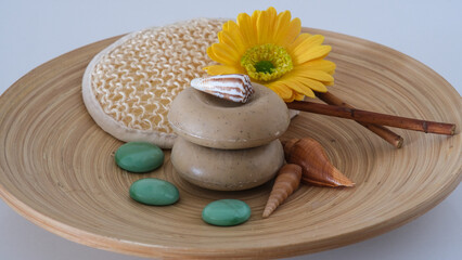 Spa concept - soaps with flower, stones and seashells