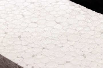 styrofoam board isolated on black background, non-toxic polystyrene material, thermoplastic and flexible resin, used in the transport, construction and food preservation industry