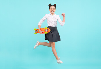 Teenagers youth casual culture. Jump and run. Teen girl with skateboard over isolated studio background. Teenager in fashion stylish clothes.