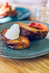 French toast with honey syrup, cream and strawberries