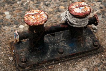old rusty iron bollard mooring device 