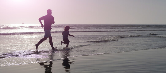 Fototapeta na wymiar Silhouette of father and son run on summer beach outdoor, banner poster with copy space, weekend family day. dad and child have fun outdoors. childhood and parenting.