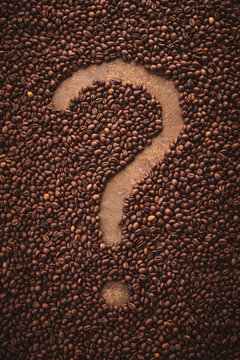 Roasted Coffee Beans And Question Mark Brown Background. Is Coffee Good Or Bad?