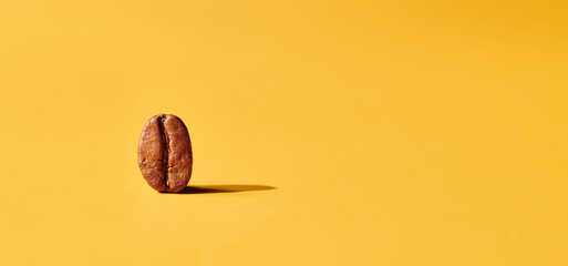 Roasted coffee beans on yellow background