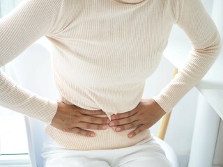 Woman with stomach pain causes of abdominal pain include inflammatory bowel disease-IBD. stomach...