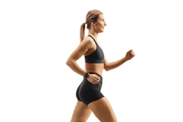 Fototapeta na wymiar Profile shot of a strong young woman in sportswear running