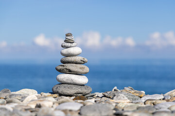 Rock balancing on ocean beach