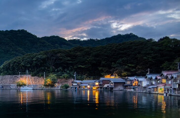 Fototapeta na wymiar Hint of sunset in clouds over small fishing village on Sea of Japan coast