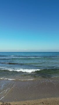 Sea waves gently crash on the beach coast. Givat Alia, Jaffa, Israel. High quality 4k footage