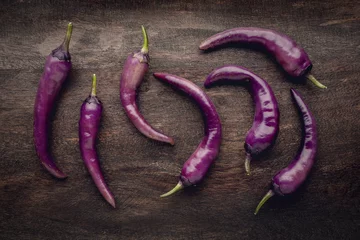 Fotobehang Buena Mulata hot chili pepper, an ornamental and edible cayenne variety, freshly picked in its purple stage © eurobanks