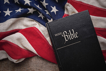 Christian Holy Bible placed on a vintage American flag
